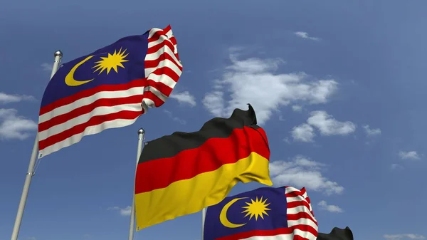 Vlajky Malajsie a Německa proti modrému nebi, prostorové vykreslování — Stock fotografie