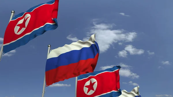 Zwaaiende vlaggen van Noord-Korea en Rusland, 3D-rendering — Stockfoto
