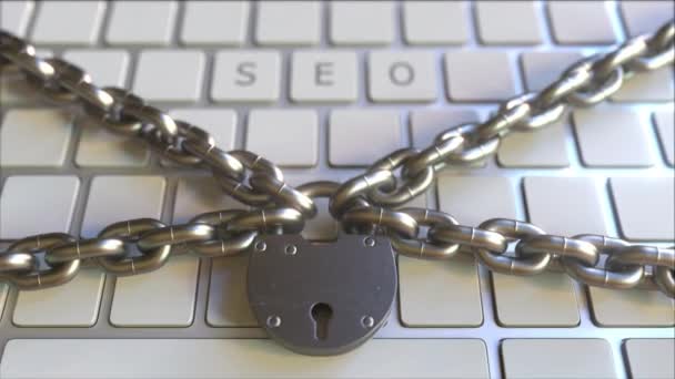 SEO word on the keyboard with padlock and chains. Conceptual 3D animation — 图库视频影像