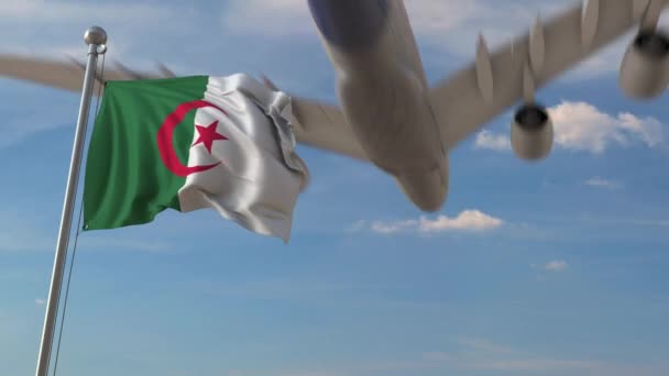 Airplane flying over flag of Algeria. Algerian air transportation related 3D animation — Stock Video