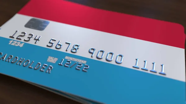 Bank card featuring flag of Luxembourg. Luxembourgian national banking system related 3D rendering — Stock Photo, Image