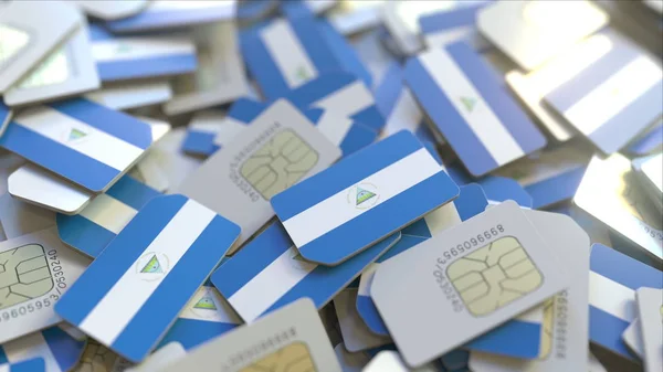 Many SIM cards with flag of Nicaragua. Nicaraguan mobile telecommunications related 3D rendering — Stock Photo, Image