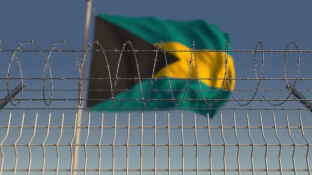 Létající vlajka Bahamu za ostnatým drátěným plotem. Koncepčně opakující se 3D animace — Stock video