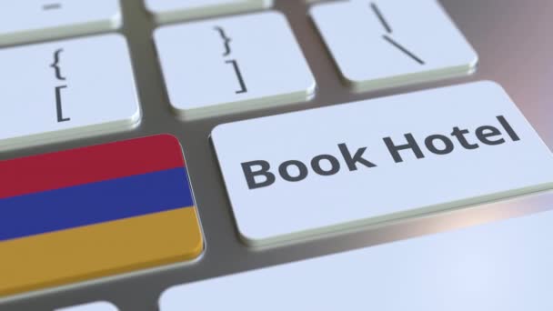 BOOK HOTEL text and flag of Armenia on the buttons on the computer keyboard. Travel related conceptual 3D animation — Stock Video