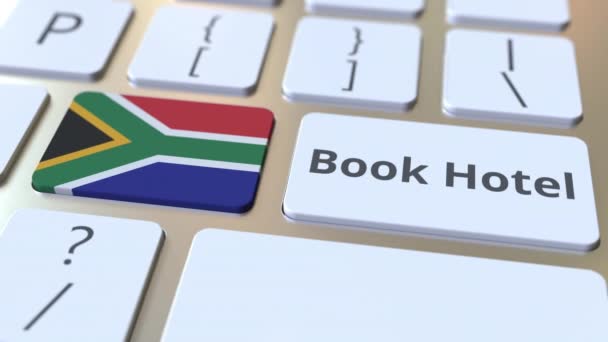 BOOK HOTEL text and flag of South Africa on the buttons on the computer keyboard. Travel related conceptual 3D animation — Stock Video