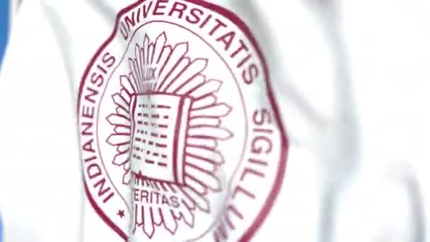 Флаг с эмблемой Индианского университета, крупным планом. Передвижная 3D-анимация — стоковое видео