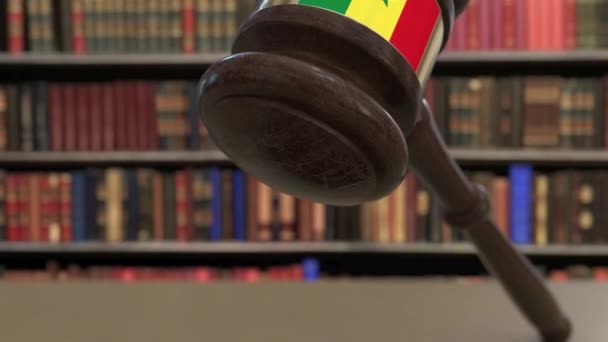 Flag of Senegal on falling judges gavel in court. National justice or jurisdiction related conceptual 3D animation — Stock Video