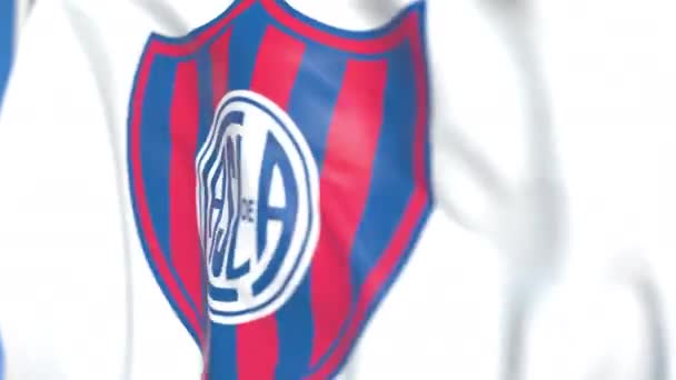 Bandera ondeando con el logo del club de fútbol San Lorenzo de Almagro, de cerca. Animación en 3D loopable editorial — Vídeo de stock