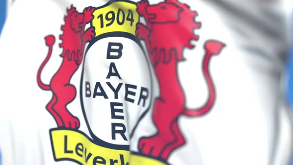 Fahne schwenkend mit Vereinslogo von Bayer Leverkusen, Großaufnahme. redaktionelles 3D-Rendering — Stockfoto