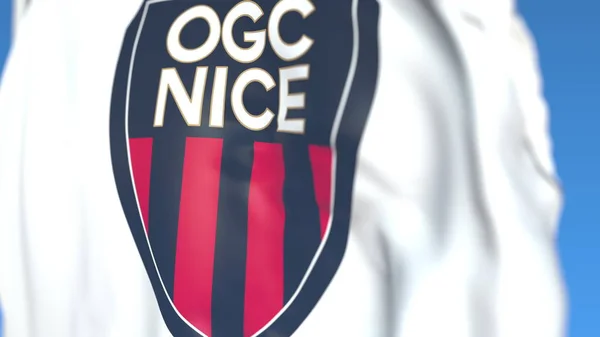 Bandiera sventolante con logo della squadra di calcio di Nizza, primo piano. Rendering editoriale 3D — Foto Stock