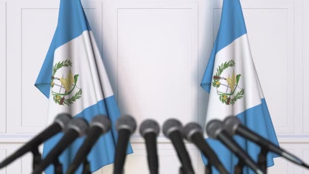 Guatemalan official press conference. Flags of Guatemala and microphones. Conceptual 3D animation — Stock Video