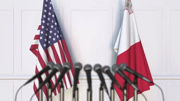 Banderas de los Estados Unidos y Malta en reuniones o conferencias internacionales. Renderizado 3D —  Fotos de Stock