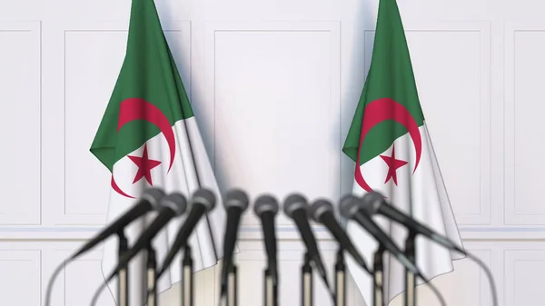 Algerian official press conference. Flags of Algeria and microphones. Conceptual 3D rendering — Stock Photo, Image