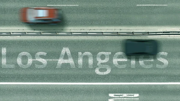 Aerial down view of the motorway with cars revealing Los Angeles caption. Car travel to the United States 3D rendering — Stock Photo, Image