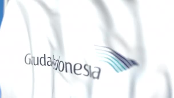 Zwaaiende vlag met Garuda Indonesia-logo, close-up. Redactionele loop bare 3D-animatie — Stockvideo