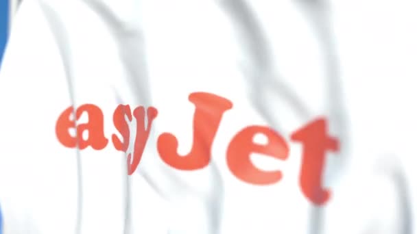 Latająca flaga z logo easyJet, zbliżenie. Redakcyjnej pętli animacji 3D — Wideo stockowe