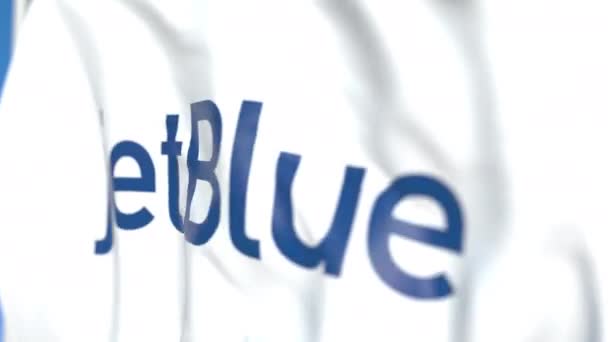 Flying flag with JetBlue logo, close-up. Editorial loopable 3D animation — Stock Video