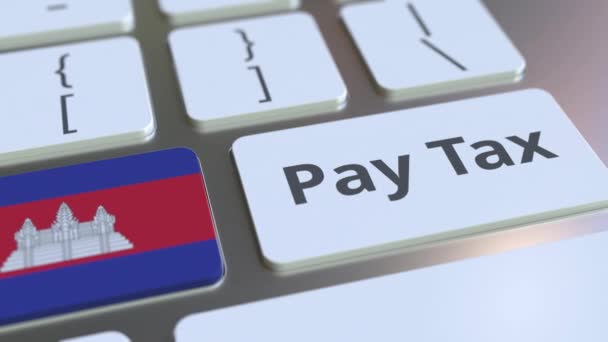 Текст PAY TAX и флаг Камбодии на кнопках на клавиатуре компьютера. Концептуальная 3D анимация — стоковое видео
