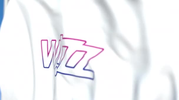 Viftande flagga med Wizz Air-logotypen, närbild. Redaktionell loopable 3D-animering — Stockvideo