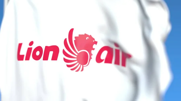 Flying flag with Lion Air logo, close-up. Representación Editorial 3D — Foto de Stock