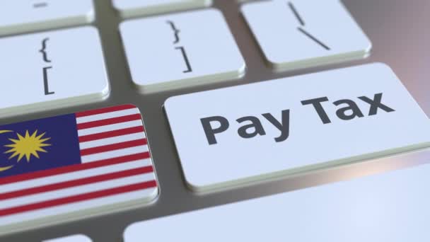 PAY TAX text and flag of Malaysia on the computer keyboard. Taxation related conceptual 3D animation — Stock Video