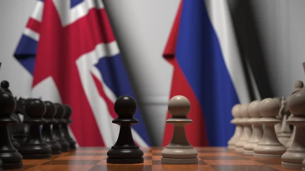 Flags of the UK and Russia behind chess board. The first pawn moves in the beginning of the game. Political rivalry conceptual 3D rendering — Stock Photo, Image