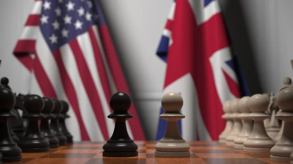 チェスボードの後ろに米国と英国の旗。最初のポーンは、ゲームの開始時に移動します。政治的ライバル概念3Dレンダリング — ストック写真