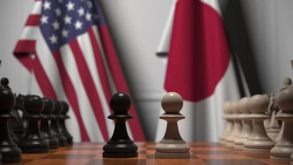 Прапори Сполучених Штатів і Японії за Шаховою Радою. Перша пішака рухається на початку гри. Політична суперництво концептуального 3D рендеринга — стокове фото