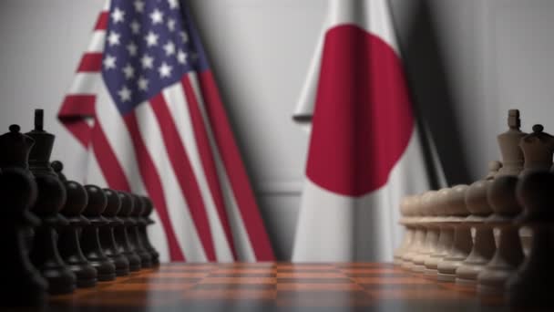 Флаги США и Японии за шахматной доской. Первая пешка движется в начале игры. Концептуальная 3D анимация — стоковое видео