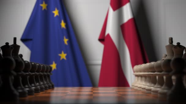 Az EU és Dánia zászlói a sakktábla mögött. Az első gyalog mozog a játék kezdetén. Politikai rivalizálás fogalmi 3D animáció — Stock videók