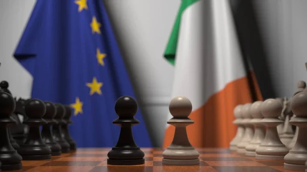 Drapeaux de l'UE et de la République d'Irlande derrière l'échiquier. Le premier pion se déplace au début du jeu. Rivalité politique rendu 3D conceptuel — Photo