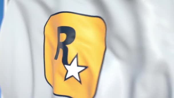 Latanie flaga z logo Rockstar Games, zbliżenie. Redakcyjnej pętli animacji 3D — Wideo stockowe