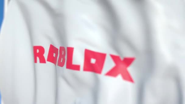 Létající vlajka s logem Roblox, zblízka. Redakční smykliatelná 3D animace — Stock video