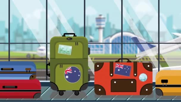 Bagagem com bandeira da Austrália adesivos no carrossel no aeroporto, close-up. Turismo australiano relacionado animação de desenhos animados loopable — Vídeo de Stock