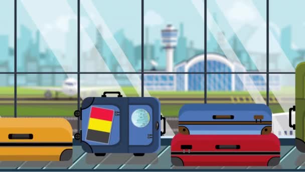 Suitcases with Belgian flag stickers on baggage carousel in airport, close-up. Tourism in Belgium related loopable cartoon animation — Stock Video