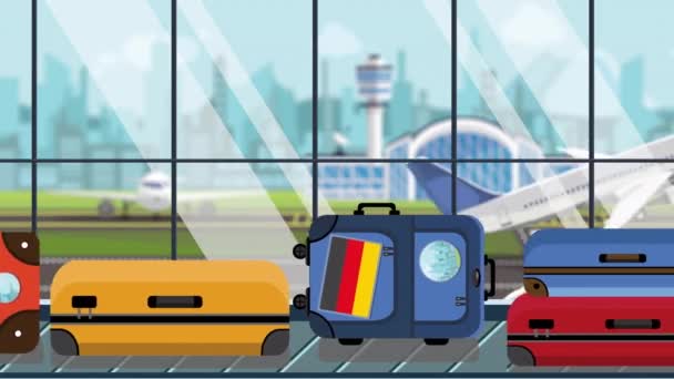 Luggage with Gegman flag stickers on baggage carousel in airport, close-up. Tourism in Germany related loopable cartoon animation — Stock Video