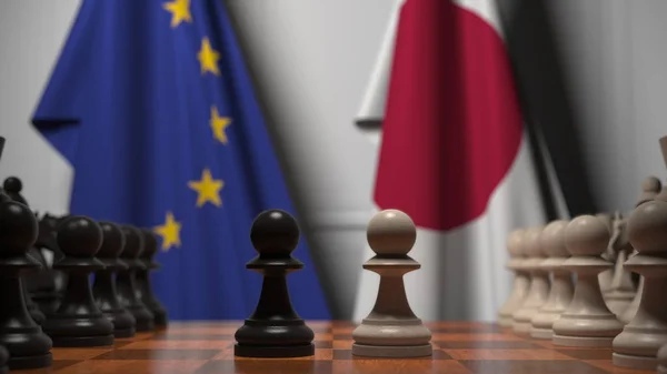 Drapeaux de l'UE et du Japon derrière l'échiquier. Le premier pion se déplace au début du jeu. Rivalité politique rendu 3D conceptuel — Photo