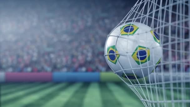 Flag of Brazil on the football hitting goal net back. Realistic slow motion 3D animation — Stock Video