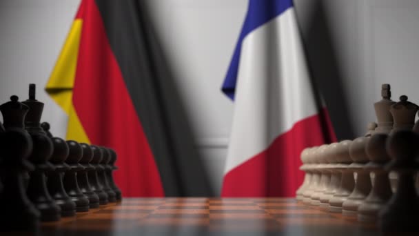 Bandeiras da Alemanha e França atrás do tabuleiro de xadrez. O primeiro peão se move no início do jogo. rivalidade política conceitual animação 3D — Vídeo de Stock