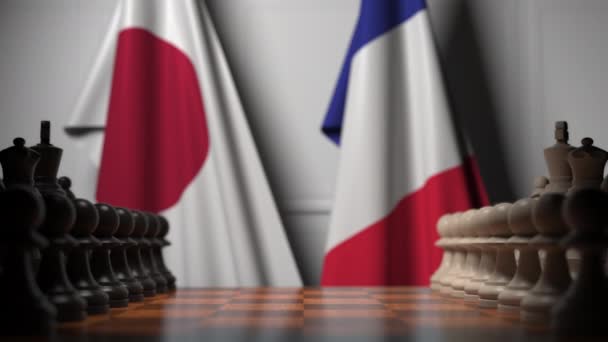 Satranç tahtasının arkasında Japonya ve Fransa bayrakları. İlk piyon oyunun başında hareket eder. Siyasi rekabet kavramsal 3d animasyon — Stok video