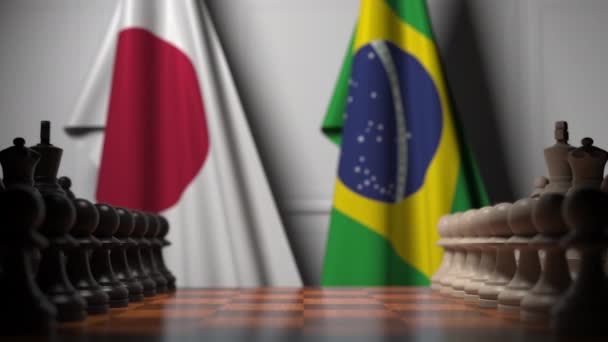 Schachspiel gegen Fahnen Japans und Brasiliens. politische Konkurrenz im Zusammenhang mit 3D-Animation — Stockvideo