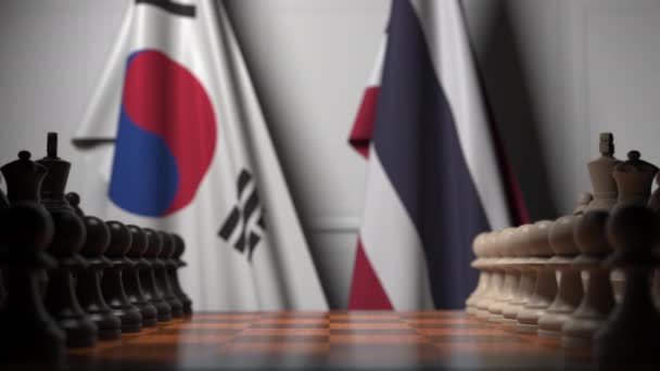 棋盘上的棋子后面是韩国和泰国的旗帜。国际象棋游戏或政治竞争相关3D动画 — 图库视频影像