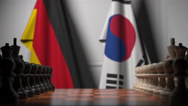 Schaakspel tegen vlaggen van Duitsland en Zuid-Korea. Politieke competitie gerelateerde 3D-animatie — Stockvideo