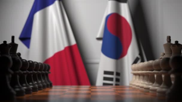 Chess game against flags of France and South Korea. Political competition related 3D animation — Stock Video