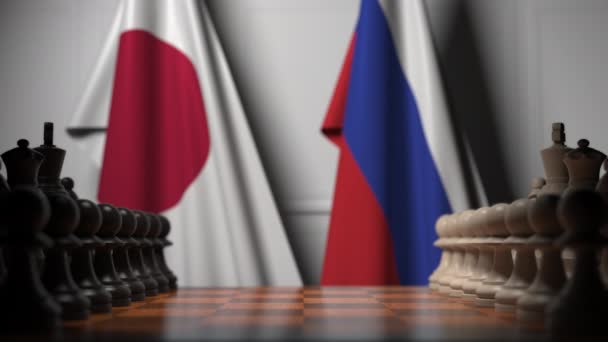 Schachspiel gegen Flaggen Japans und Russlands. politische Konkurrenz im Zusammenhang mit 3D-Animation — Stockvideo