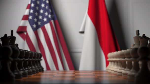 Шахматная игра против флагов США и Индонезии. Политическая конкуренция — стоковое видео