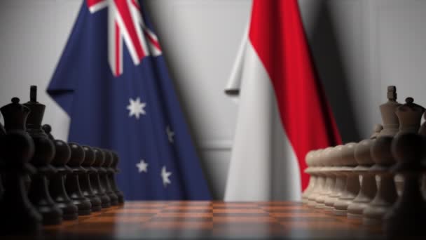 Шахматная игра против флагов Австралии и Индонезии. Политическая конкуренция — стоковое видео