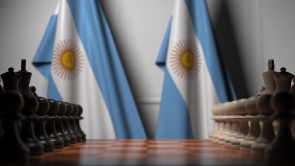 Flags of Argentina behind pawns on the chessboard. Chess game or political rivalry related 3D animation — Stock Video