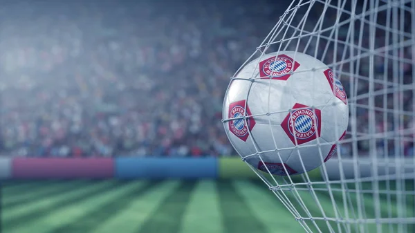 FC Bayern Munchen football club logo on the ball in football net. Editorial conceptual 3D rendering — Stock Photo, Image