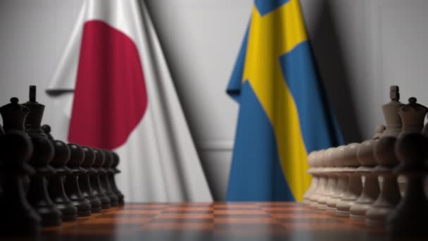 Chess game against flags of Japan and Sweden. Political competition related 3D animation — Stock Video